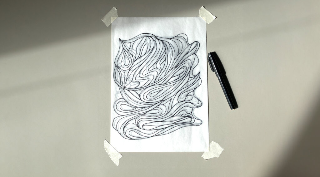 doumorh-elriz-royah-sketch A hand-drawn abstract design in black ink on paper. The image features a series of flowing, interconnected lines that create a dynamic, swirling composition. The drawing is taped to a flat surface with a black pen placed beside it.